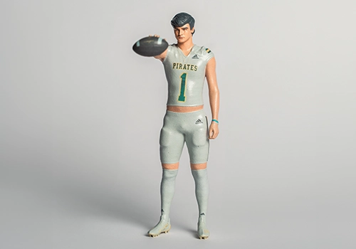Detailed 3D-printed figurine of a football player in a Pirates jersey holding a football